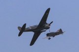 An American P-40 aircraft pursues a Japanese Zero